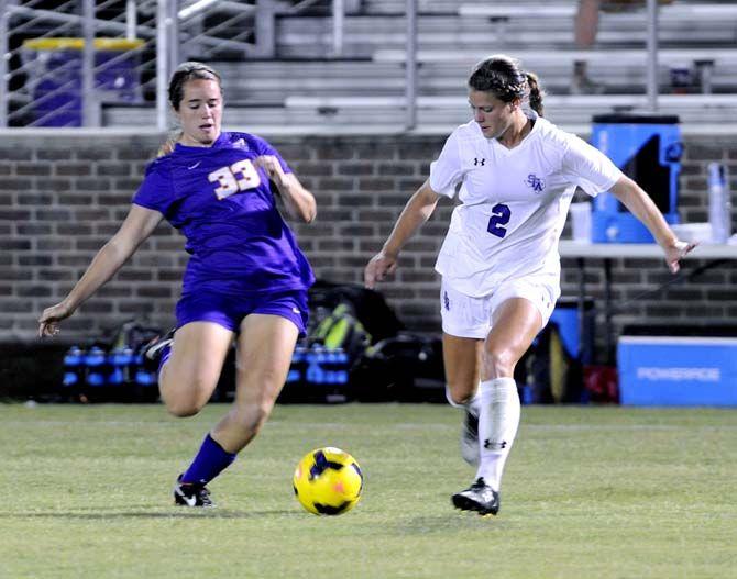 LSU forward Lexi Gibbs takes the ball from Stephen F. Austin's player Monday, September 8, 2014 at LSU soccer stadium.