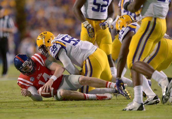 LSU senior defensive end, Jermauria Rasco (59), tackles Ole Miss senior quarterback, Bo Wallace (15) in Tiger Stadium Saturday, October 25, 2014 where LSU won 10-7.