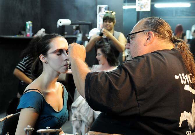 Head makeup artist and scenic artist Blaine Quam sits backstage to prepare actors' makeup for their roles in the 13th Gate.