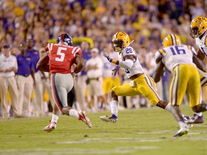 LSU junior safety, Jalen Mills (28), attacks Ole Miss junior running back, Robert Mathers (5) where Tigers won 10-7 in Tiger Stadium Saturday, October 25, 2014.