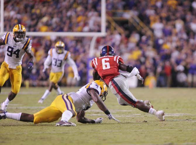 Ole Miss junior running back Jaylen Walton (6) escapes LSU tackle in Tiger Stadium Saturday, October 25, 2014.