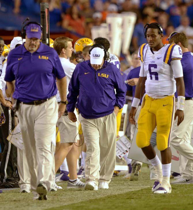 LSU freshman quaterback Brandon Harris (6) and head coach Les Miles walk down the sidelines Saturday, October 11, 2014 during the Tigers' 30-27 victory in Ben Hill Griffin Stadium.