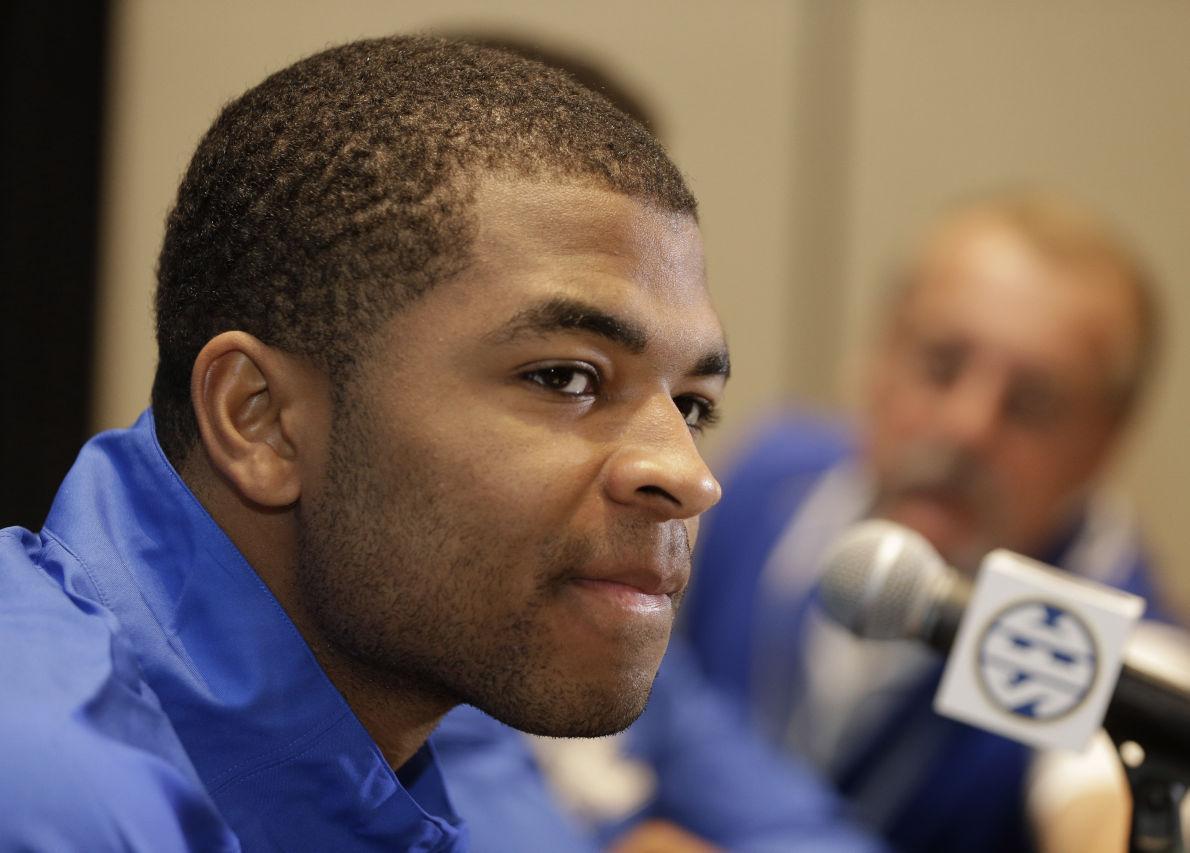 Kentucky's Aaron Harrison answers a question during a news conference at the Southeastern Conference NCAA men's college basketball media day in Charlotte, N.C., Wednesday, Oct. 22, 2014. (AP Photo/Chuck Burton)