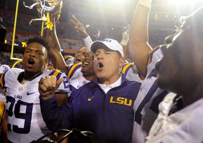 Football head coach Les Miles celebrates with his team his 100th victory with LSU Saturday, October 11, 2014 during the Tigers' 30-27 victory in Ben Hill Griffin Stadium.