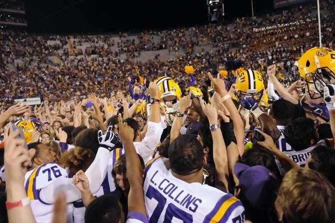 LSU senior offensive tackle La'el Collins (70) celebrates alongside teamates and students as they rush the field after Tigers' 10-7 victory against Ole Miss Saturday, October 25, 2014 in LSU Tiger Stadium.