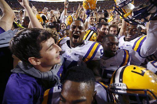 LSU defensive end Justin Maclin, center, celebrates amongst swarming fans after the team defeated Mississippi in an NCAA college football game in Baton Rouge, La., Saturday, Oct. 25, 2014. LSU won 10-7. (AP Photo/Jonathan Bachman)