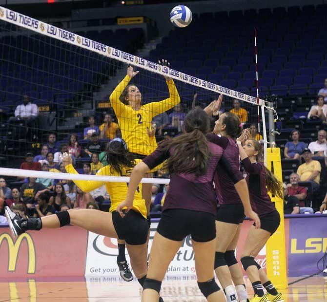 LSU junior outside hitter Emily Ehrle (2) jumps to spike the ball during Tiger's victory 3-0 against Mississippi State Wednesday, October 8, 2014 in the PMAC.