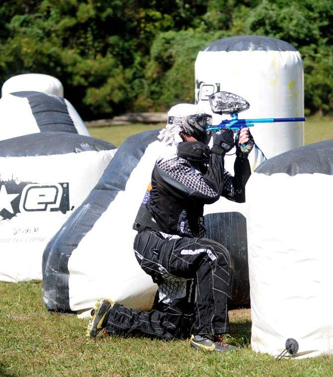 Team member of LSU's Tiger Paintball, Brett Taliaferro, crouches behind an inflatable wall in a round of speedball at Paintball Command in Mandeville Sunday, October 19, 2014.