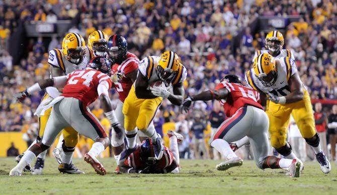 LSU freshman runningback, Leonard Fournette (7), gets tackled against Ole Miss, who leads 7-3 during halftime in Tiger Stadium on Saturday, October 25, 2014