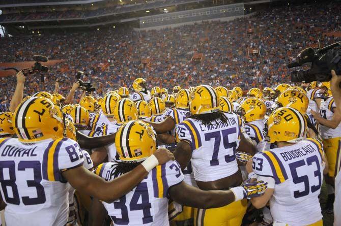 LSU football players celebrate their 30-27 victory against Florida Saturday, October 11, 2014 in Ben Hill Griffin Stadium.