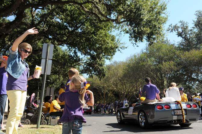 Fans wave at the Homecoming Parade Saturday, October 25, 2014.