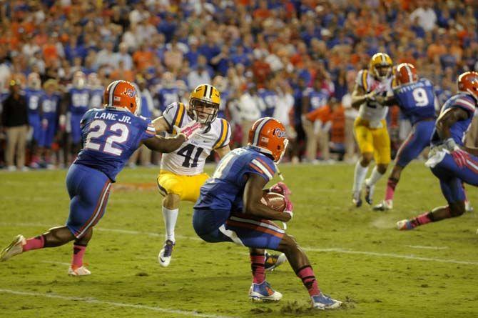 Florida senior wide reciever Andre Debose (4) runs the ball while freshmen running back Adam Lane Jr. (22) stops junior saftery Tommy LeBeau (41) Saturday, October 11, 2014 during the Tigers' 30-27 victory in Ben Hill Griffin Stadium.