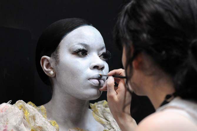 A makeup artist works on an actor backstage before showtime at 13th Gate.