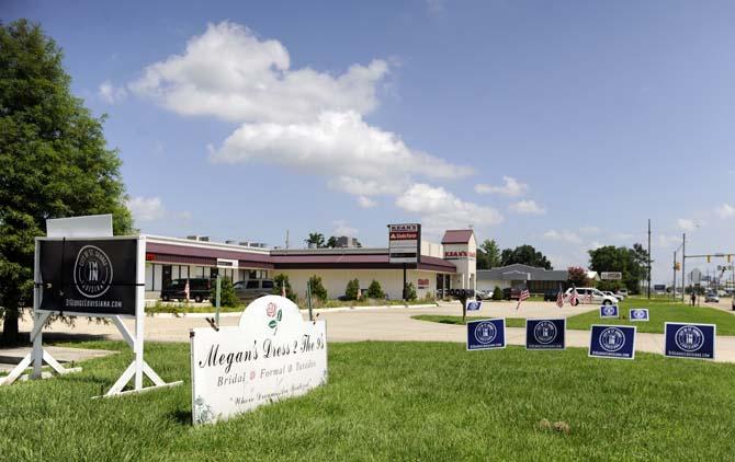 Signs encouraging citizens to sign a petition instituting the area of St. George as a city are arranged outside of Megan's Dress 2 the 9's Wednesday, June 18, 2014.