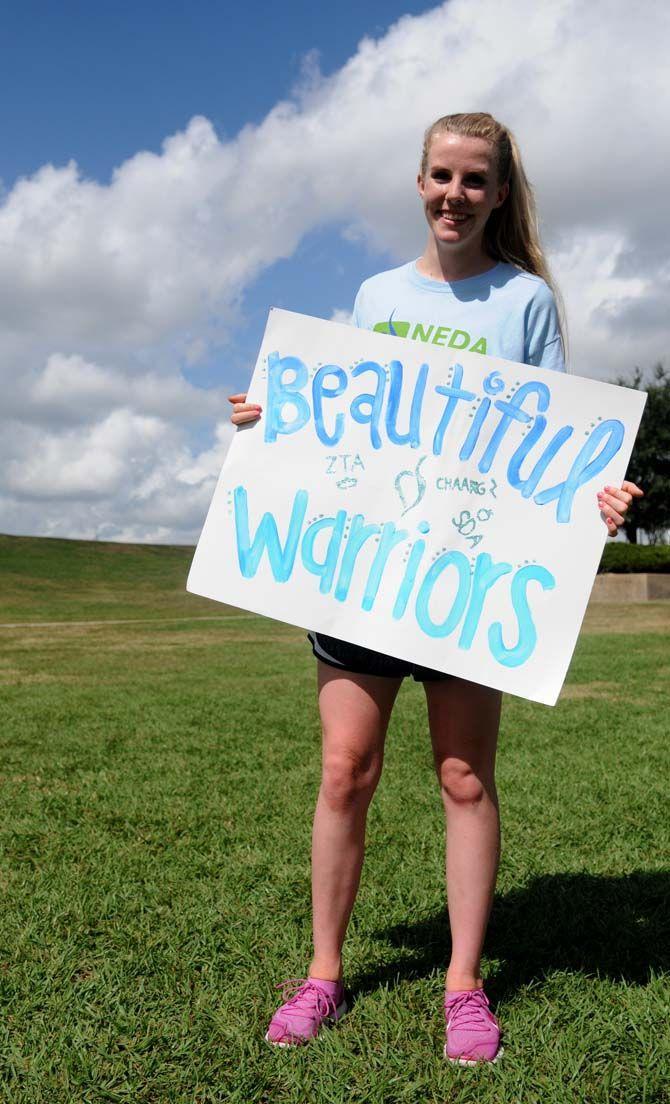 LSU's Zeta Tau Alpha sophmore Anna McKay holds her sign for the National Eating Disorder Association (NEDA) walk at the Riverfront Plaza on October 11, 2014.