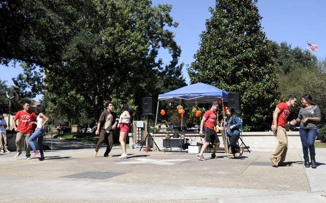 Members of the Hispanic Student Cultural Society and Phi Lota Alpha fraternity dance to hispanic music on Tuesday at Free Speech Plaza.