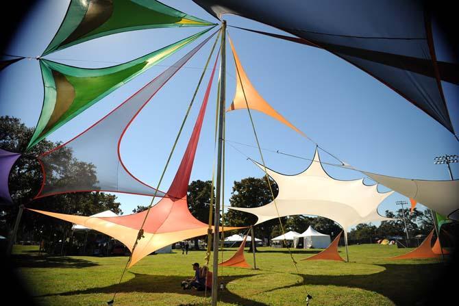 Festival goers take a break under a large tent Friday, Nov. 1, 2013 at the 2013 Voodoo Music + Arts Experience.