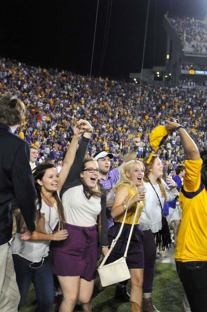 Fans rush onto the field in Tiger Stadium after a win against Ole Miss 10-7 Saturday, October 25, 2014.