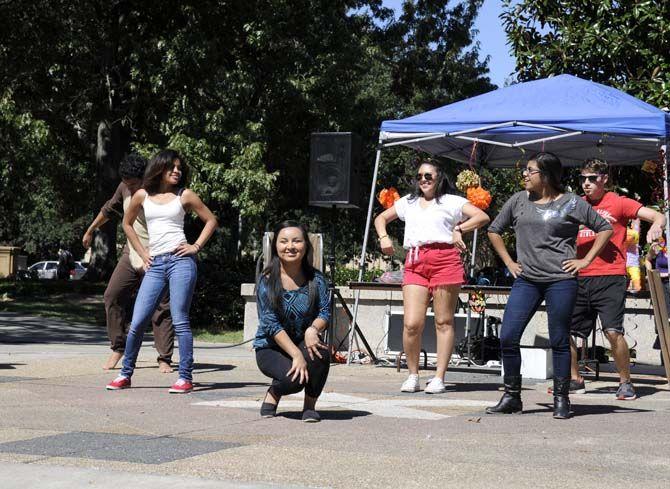 Members of the Hispanic Student Cultural Society and Phi Lota Alpha fraternity dance to hispanic music on Tuesday at Free Speech Plaza.