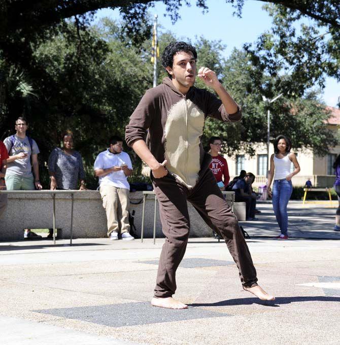 Jose Lloveras-Fuentes, a Theater Senior, participates in a flash mob with HSCS Tuesday at Free Speech Plaza.