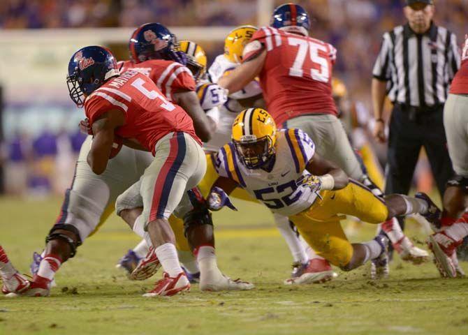 LSU sophomore linebacker, Kendell Beckwith (52), takles Ole Miss junior running back, Robert Mathers (5), Tiger Stadium Saturday, October 25, 2014 where Tigers won 10-7..