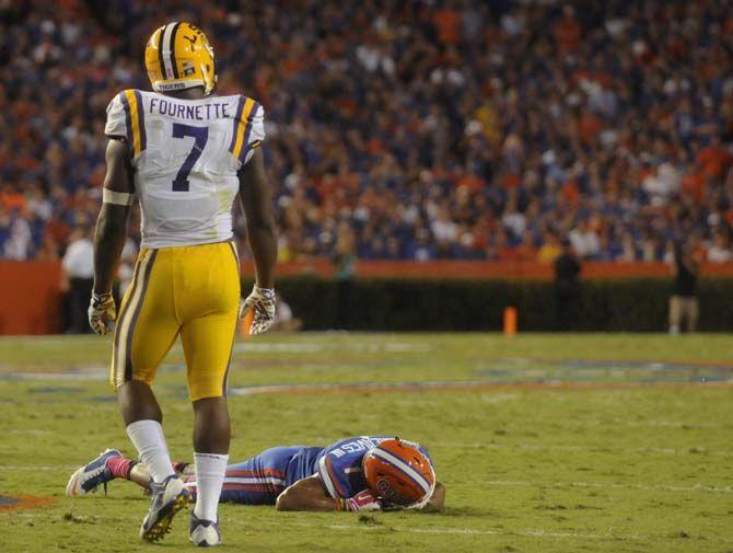 LSU freshman running back Leonard Fournette (7) walks past injured sophomore defensive back Vernon Hargreaves III (1) Saturday, October 11, 2014 during the Tigers' 30-27 victory in Ben Hill Griffin Stadium.