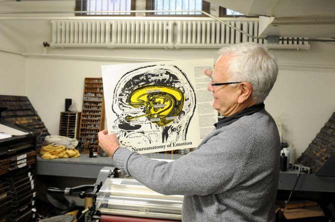 Artist and doctor Eric Avery holds up an artwork modeled after his own brain titled &#8220;Neuroanatomy of Emotion.&#8221; The piece was printed on the backside of writings about depression and folded into a book.