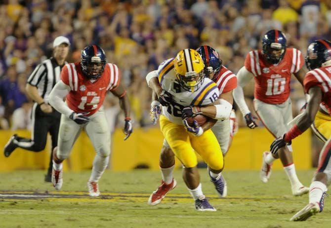 LSU senior running back Terrence Magee runs the ball as Ole Miss defender tries to tackle him during Tiger's 10-7 victory Satruday, October 25, 2014 in Tiger Stadium