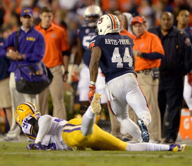 Auburn senior running back Cameron Artis-Payne (44) runs the ball past LSU freshman defensive end Deondre Clark (98) Saturday, October 4, 2014 during the LSU Tigers' 41-7 loss against the Auburn Tigers in Jordan-Hare Stadium.