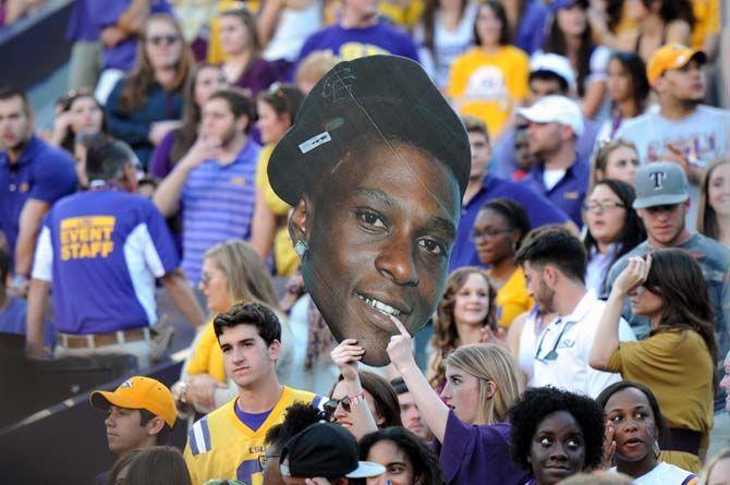 A fan holds up a Lil Boosie sign in the crowd at Tiger Stadium Saturday, October 25, 2014.