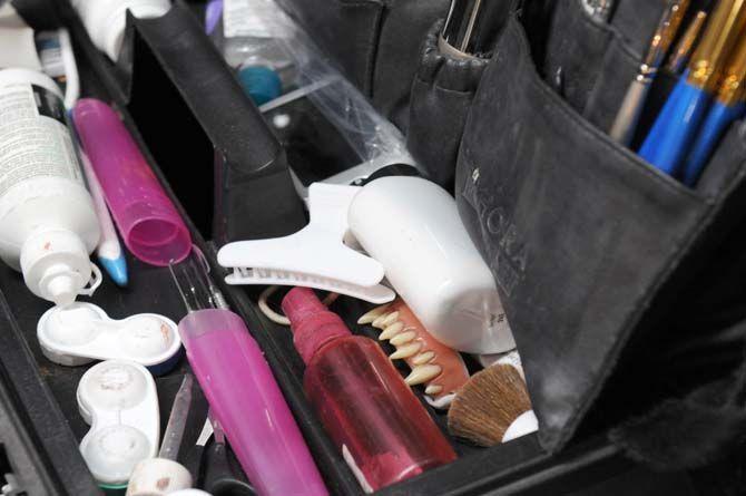 A set of artificial fangs sit in a makeup artist's toolkit backstage at the 13th Gate.