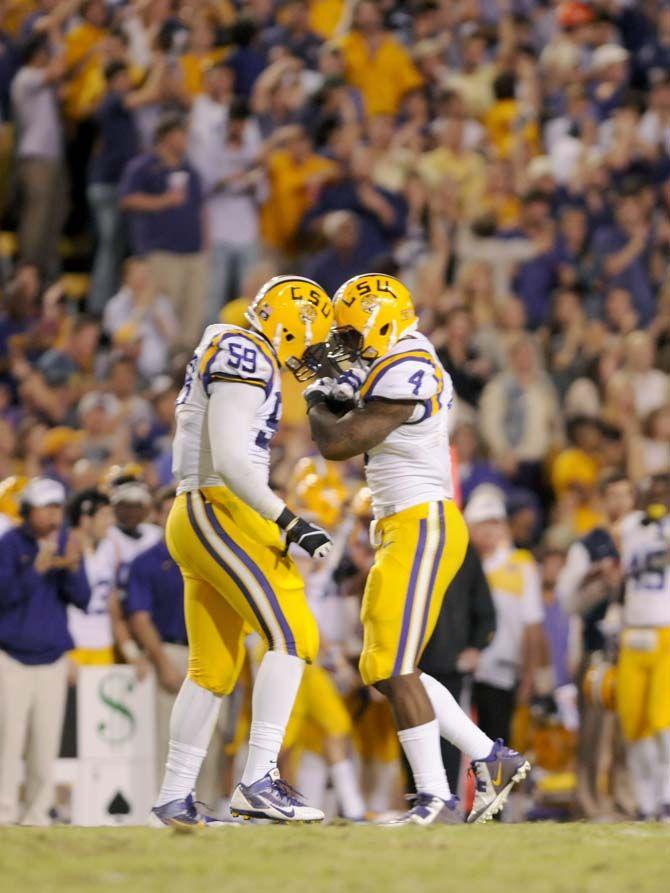 LSU senior defensive end, Jermauria Rasco (59), celebrates a play with junior linebacker, Kwan Alexander (4), in Tiger Stadium Saturday, October 25, 2014 where LSU won 10-7.