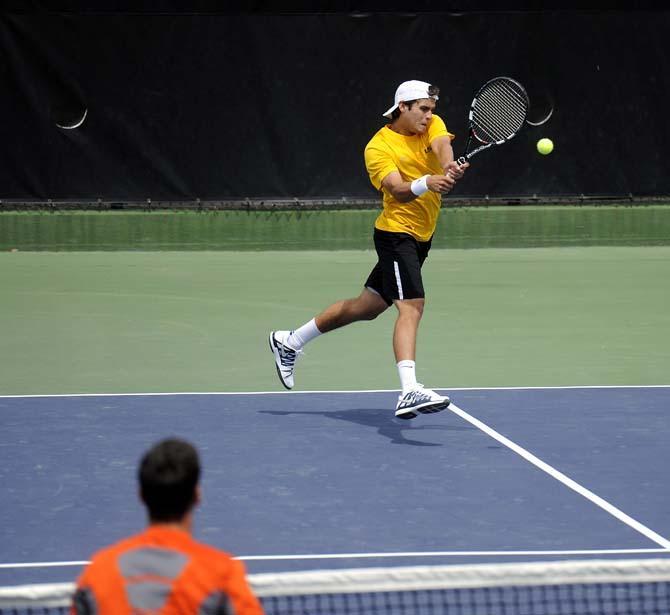 LSU freshman Eric Perez hits a volley Sunday, March 30, 2014 during the Men's Tennis doubles match against Florida at W.T. "Dub" Robinson Stadium.