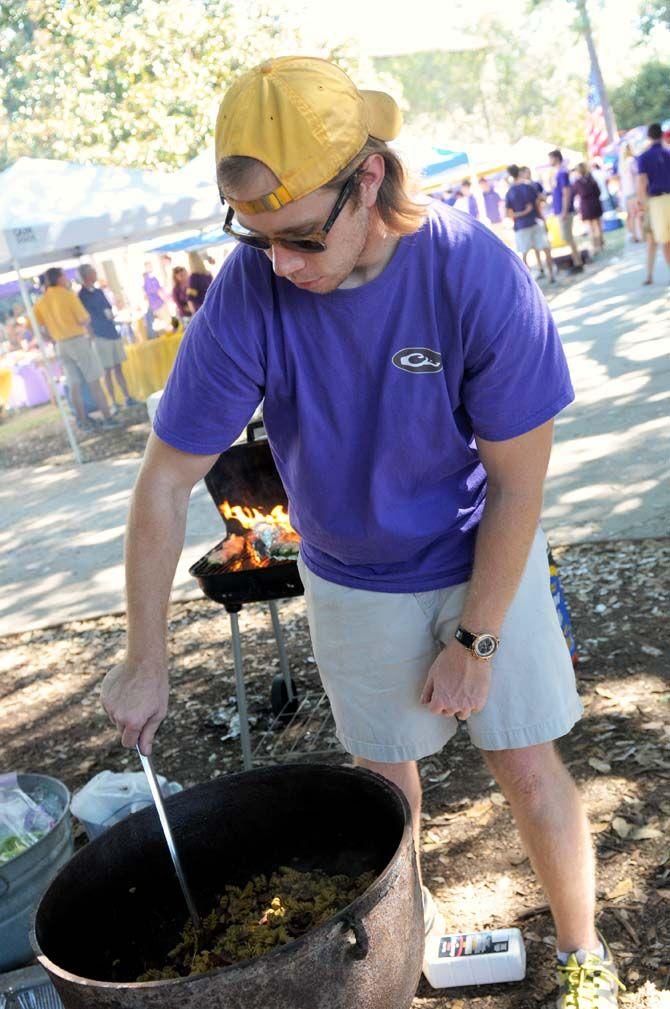 A man cooks for his family for the first time at a tailgate Saturday, October 25, 2014 before the LSU game against Ole Miss.