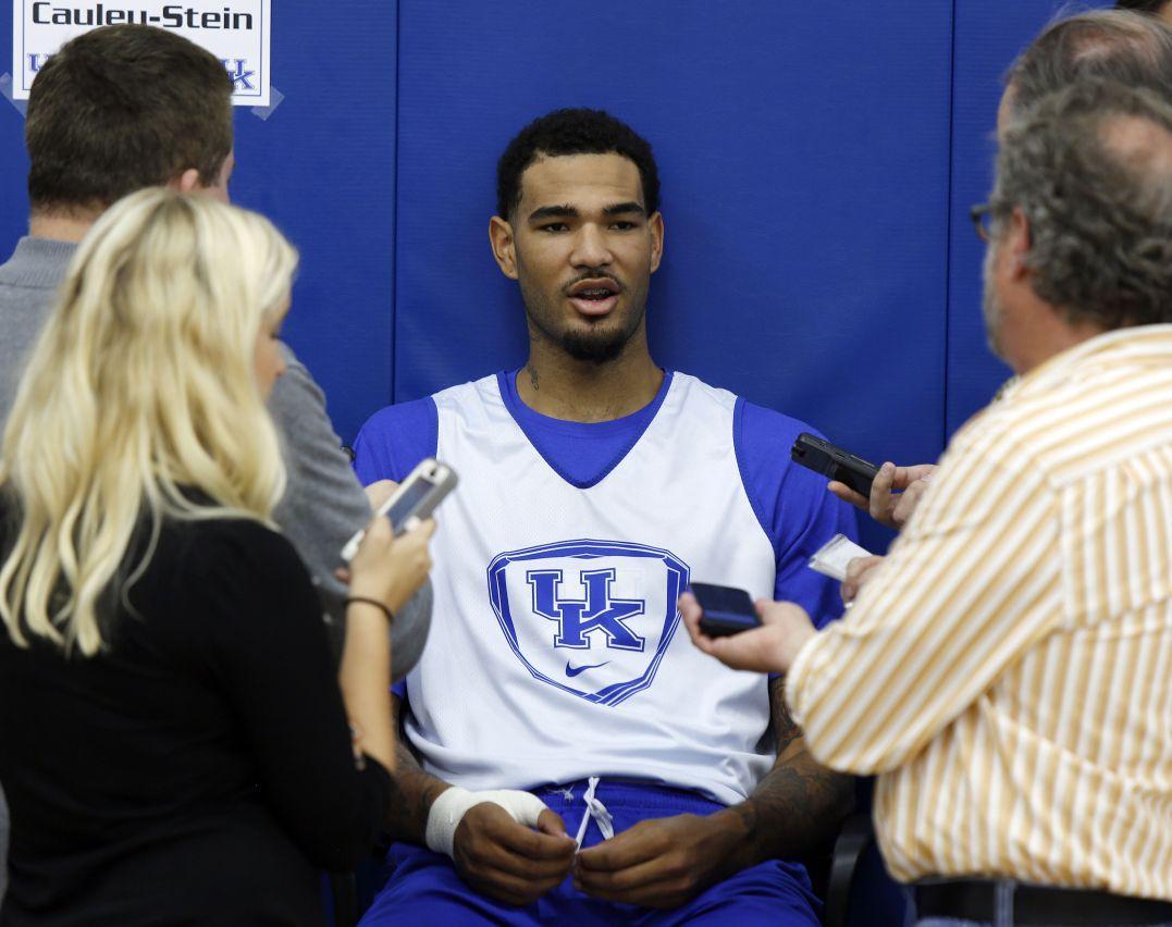 Kentucky's Willie Cauley-Stein, center, speaks to reporters during the team's NCAA college basketball media day, Thursday, Oct. 16, 2014, in Lexington, Ky. (AP Photo/James Crisp)