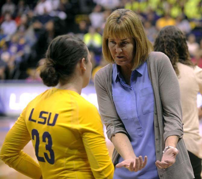 LSU volleyball head coach Fran Flory instructs freshman setter/deffensive specialist Cheyenne Wood (23) during Tiger's victory 3-2 against Arkansas Sunday, October 5, 2014 in the PMAC.