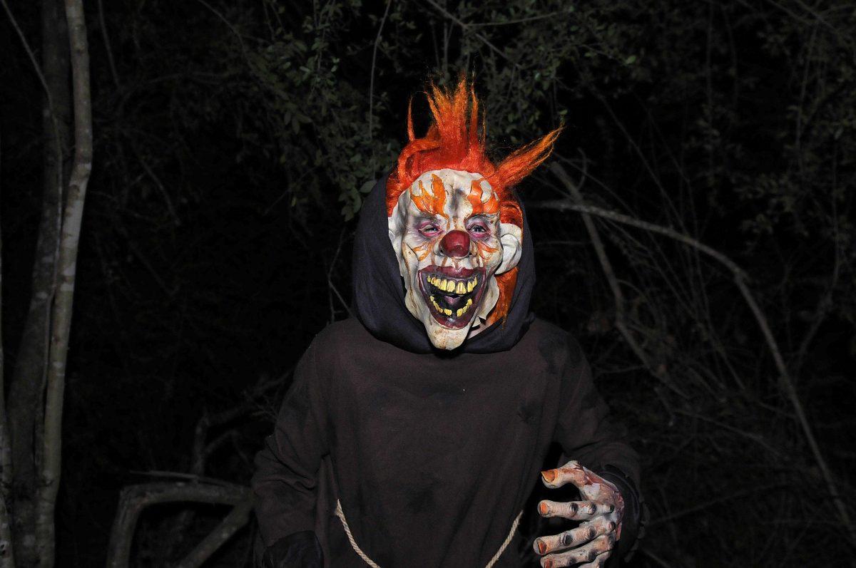 A carrot topped clown scares attendees at the Cajun Country Corn Maze on Friday night, Oct. 18 in Pine Grove, Louisiana.