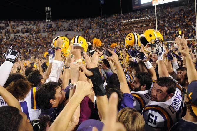 LSU football players and students rush the field and celebrate the Tigers' 10-7 victory against Ole Miss Saturday, October 25, 2014 in LSU Tiger Stadium.