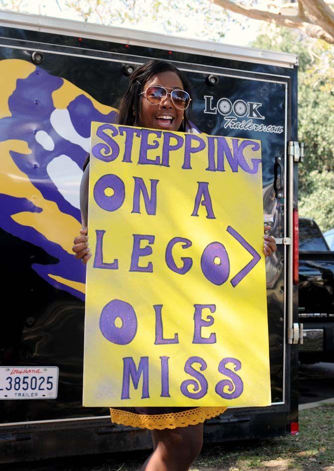 A fan holds a sign dissing Ole Miss Saturday, October 25, 2014.