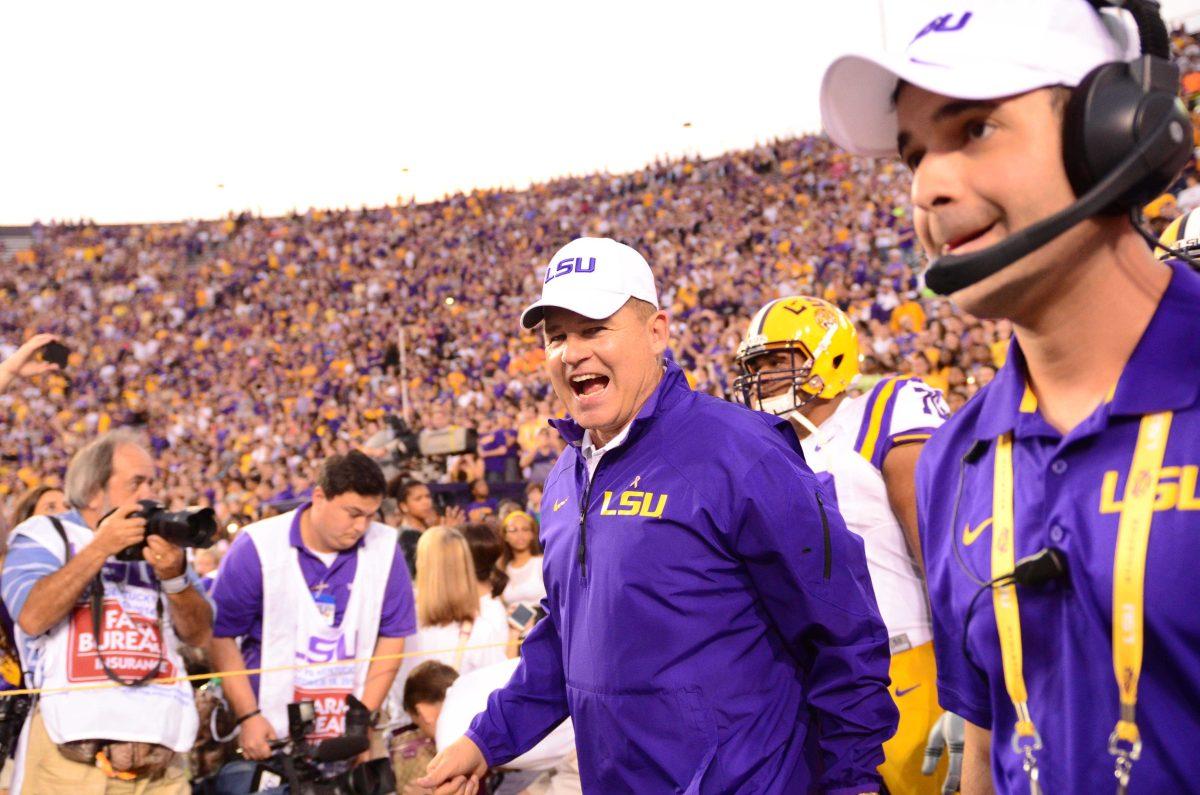 LSU's head coach Les Miles leads LSU football players on to the field at the LSU vs Kentucky game at Tiger Stadium October 18, 2014.