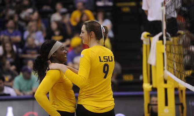 LSU senior middle blocker/right side Madi Mahaffey (9) hugs freshman outside hitter Gina Tillis (12) during the Tigers' 1-3 defeat against Florida Friday, October 3, 2014 in the PMAC.