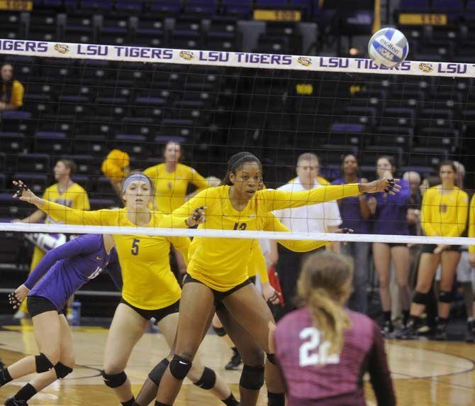 LSU sophomore middle blocker Briana Holman (13) and freshman setter Elly Ogle (5) coordinate a play during Tiger's victory 3-0 against Mississippi State Wednesday, October 8, 2014 in the PMAC.