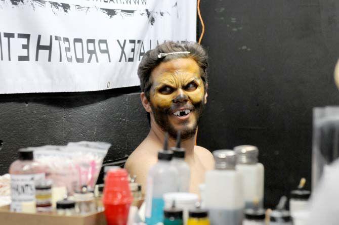 An actor at the 13th Gate looks at himself for the first time after getting his makeup done before showtime.