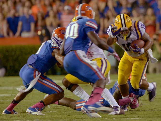 LSU senior running back Terrence Magee (18) runs the ball Saturday, October 11, 2014 during the Tigers' 30-27 victory in Ben Hill Griffin Stadium.