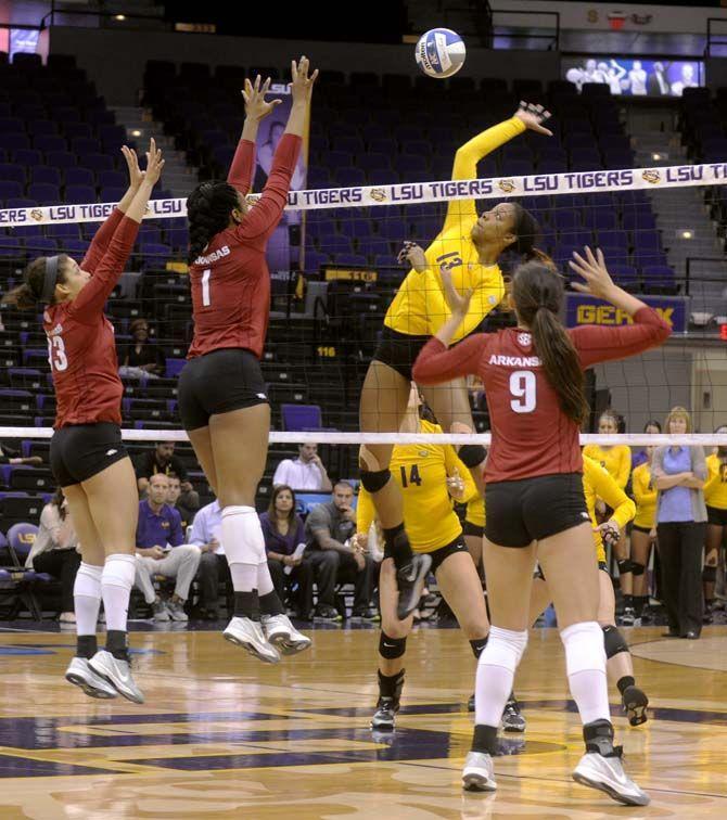 LSU sophomore middle blocker Briana Holman (13) spikes the ball during Tiger's victory 3-2 against Arkansas Sunday, October 5, 2014 in the PMAC.