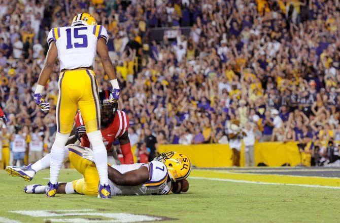 LSU freshman wide receiver, Malachi Dupre (15), stands over freshman running back, Leonard Fournette (7) after being tackled in Tiger Stadium Saturday, October 25, 2014 where Tigers won 10-7. .