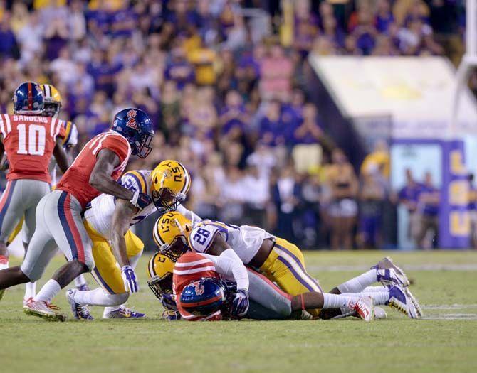 LSU junior safety Jalen Mills (28) tackles Ole Miss wide receiver Cody Core (88) in a Tigers' win 10-7 Saturday, October 25, 2014.