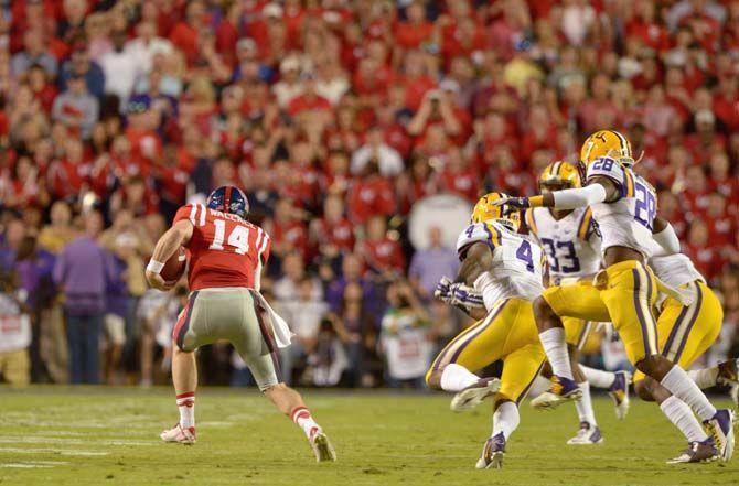 Ole Miss senior Bo Wallace (14) runs the ball during Tigers' 10-7 victory Saturday, October 25, 2014 in the Tiger Stadium.