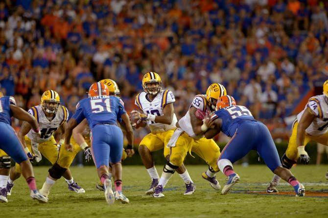 LSU sophomore quarterback Anthony Jennings (10) snaps the ball and prepares to pass it Saturday, October 11, 2014 during the Tigers' 30-27 victory in Ben Hill Griffin Stadium.