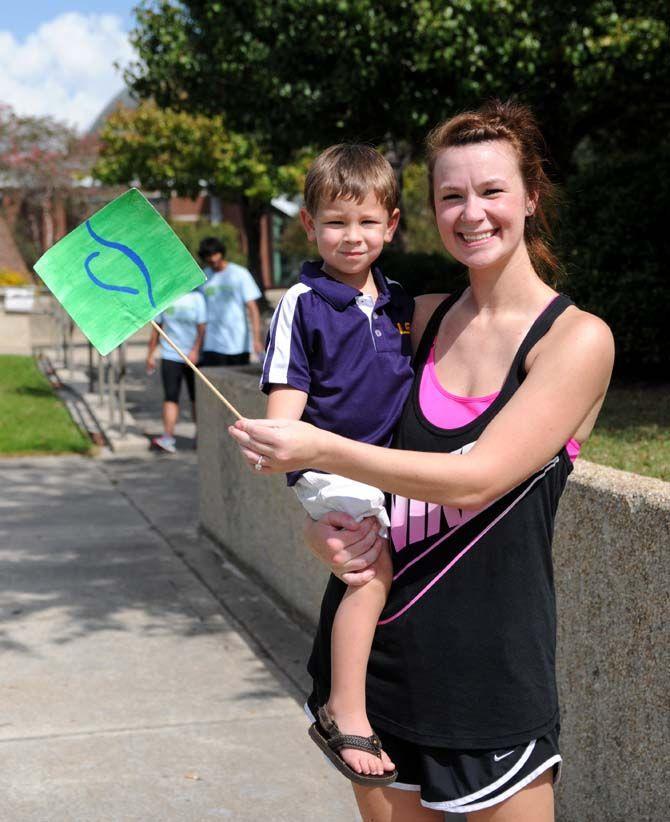 Participants cross the finish line at the National Eating Disorder Association (NEDA) walk at the Riverfront Plaza on October 11, 2014.